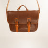 Handmade Morgan Messenger Bag in brown leather with adjustable strap against a white background. Leathercraft design by Vasile and Pavel.