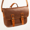Handmade Morgan Messenger Bag in brown leather with adjustable strap against a white background. Leathercraft design by Vasile and Pavel.